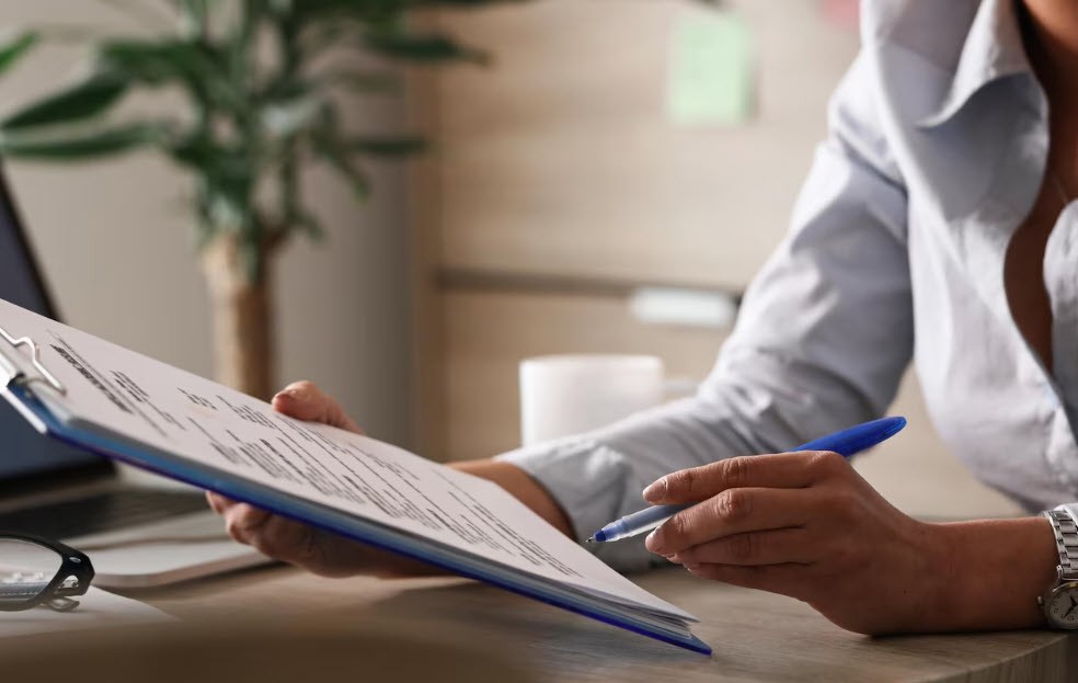 Person filling out a patient form on a clipboard in Edmonds Washington